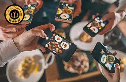 People taking photos of restaurant dishes with smartphones as social proof