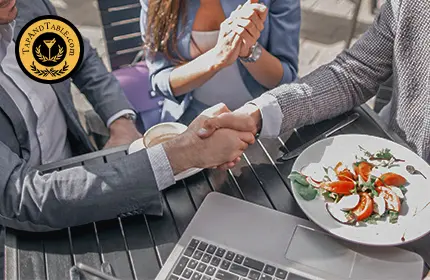 Restaurant owner reviewing produce delivery with food vendor
